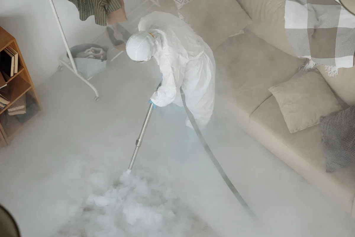 Biohazard cleanup technician in protective equipment, Madison, OH